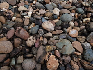abstract Textured background with round pebble stones. Vacation holiday recreation on beach concept. High quality photo. Fragment with a texture of rock.