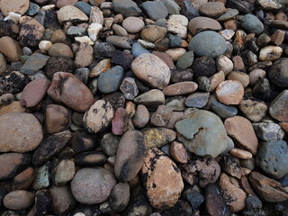 abstract Textured background with round pebble stones. Vacation holiday recreation on beach concept. High quality photo. Fragment with a texture of rock.