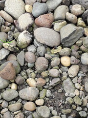 abstract Textured background with round pebble stones. Vacation holiday recreation on beach concept. High quality photo. Fragment with a texture of rock.