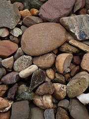abstract Textured background with round pebble stones. Vacation holiday recreation on beach concept. High quality photo. Fragment with a texture of rock.