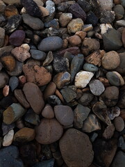 abstract Textured background with round pebble stones. Vacation holiday recreation on beach concept. High quality photo. Fragment with a texture of rock.
