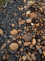 abstract Textured background with round pebble stones. Vacation holiday recreation on beach concept. High quality photo. Fragment with a texture of rock.