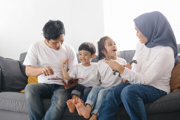 Parents Teaching Kids, Father Reading Story on Books to Daughter and Son at Home