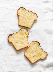 Slice of rich french brioche on a light background, top view
