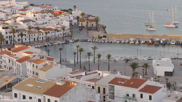 Top view panorama of the stylish Fornells harbor in warm light of sunset in Menorca Island Spain