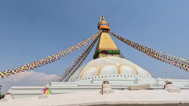 circling around Large emblematic Stupa with eyes and prayer flags. Boudhanath, Khasti Chaitya and Khasa Chaitya is a stupa in Kathmandu, Nepal