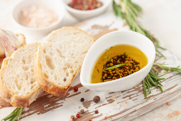 Bread dipping oil. Crusty bread ciabatta and bowl of olive oil with spices.