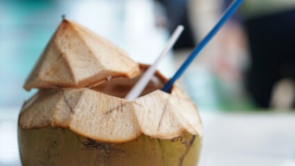 Degan ice a drink from young coconut with a blur background. Degan ice is famous drink on the beach