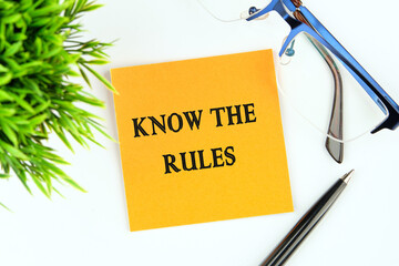 Know the rules text on an orange sticker on a white background