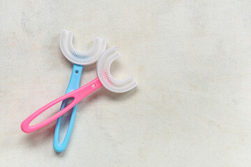 Children's toothbrushes on white grunge background