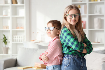Cute little children in eyeglasses at home