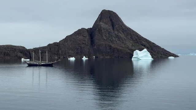 Three-masted schooner in the fjord with growlers at Bear Islands. Scoresbysund, Greenland.