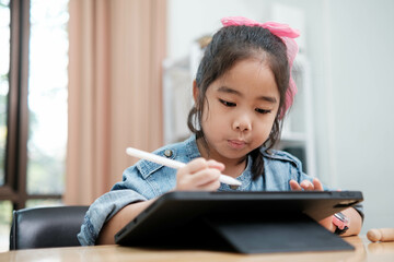 Young Girl Drawing on Digital Tablet with Stylus Pen