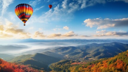 Fototapeta premium A hot air balloon is flying over a beautiful mountain range