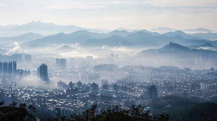 Fototapeta na wymiar A panoramic view of a city covered in smog as seen from the mountains