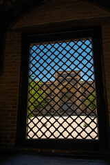 View through the window to the ancient madrasah, Bukhara, Uzbekistan.