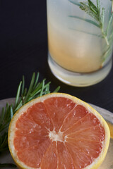 Fototapeta premium Cut Grapefruit and garnish next to cocktail