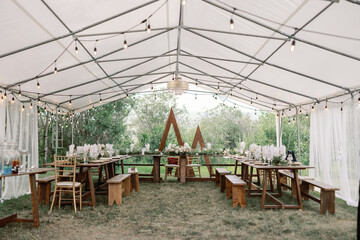 Elegant outdoor tented wedding reception setup