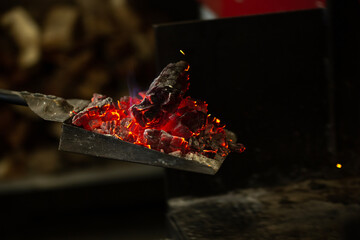 Red hot embers on a tray in a restaurant kitchen