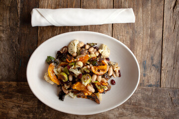 Overhead view of vegetable goulash on rustic wood table