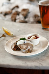 Oyster on a half shell on marble counter vertical