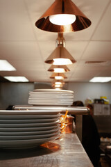 View under heat lamps in a restaurant kitchen vertical