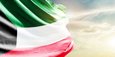 Kuwait national flag waving in the sky.