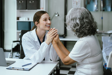 Female doctors shake hands with patients encouraging each other To offer love, concern, and...