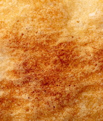 Ruddy crust of bread as an abstract background. Texture
