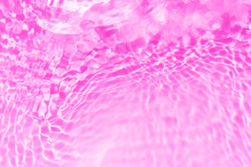 Purple water splashes on the surface ripple blur. Defocus blurred transparent pink colored clear...