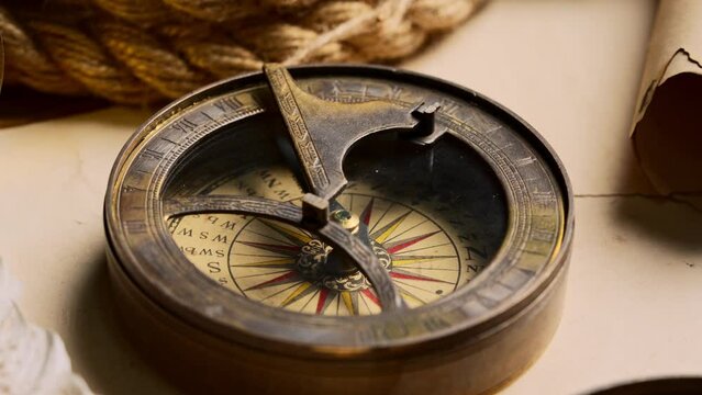 Antique Nautical Compasses on an Old World Map in Soft Lighting