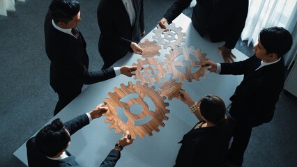 Top view of business people gather wooden cog together at meeting. Group of project manager helping...