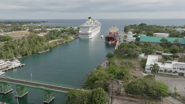 Ships moored in canal of La Romana tourist port, Dominican Republic. Aerial forward