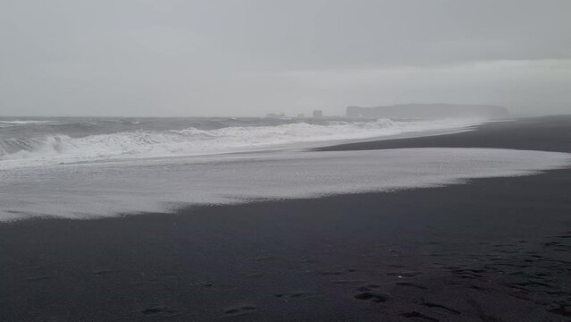 Rough Sea Waves Crashing on Reynisfjara, Black Sand Beach, Coastline of Iceland on Cold Rainy Day