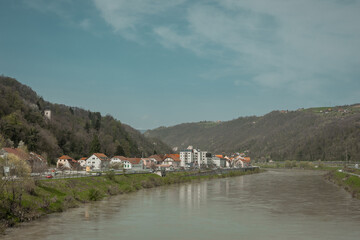 Panorama of the old town of Krsko on right Sava river bank. Looking from the road bridge connecting both sides. Sunny spring day in March