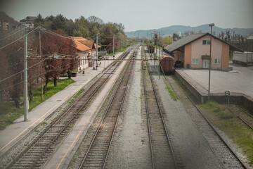 Fototapeta na wymiar Train station of Krsko seen from the railway overpass, looking towards south. Some empty tracks seen, station before renovation.