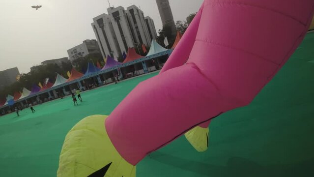 The video showcases the vibrant and joyous celebration of the kite festival in Ahmedabad, India. The sky is adorned with a multitude of colorful kites of various shapes and sizes, creating a