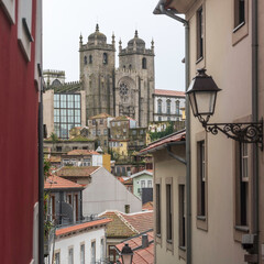 View at the Se cathedral of Porto through a street with an old street lamp opn the wall, Portugal.