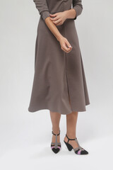 Fototapeta premium Serie of studio photos of female model in patterned brown midi dress, autumn winter fashion collection.