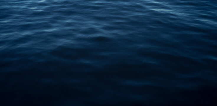 Blue water ocean surface, calm dark sea background