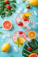 Two glasses of fruit punch with ice and straws on a blue background