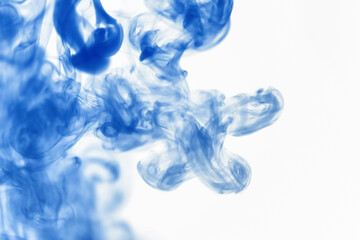 Puffs of paint in water. The dissolution of the dye in water. Water pollution. Concept art...