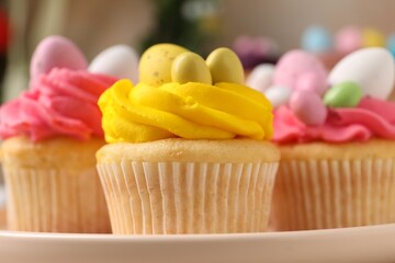 Tasty decorated Easter cupcakes on table, closeup