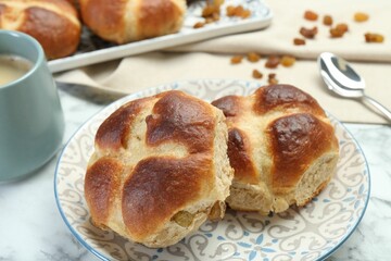 Hot cross buns served on white marble table