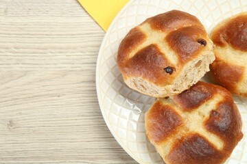 Hot cross buns on wooden table. Space for text