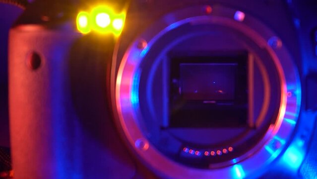 camera shutter mirror takes photos against a dark background with blue red backlighting 