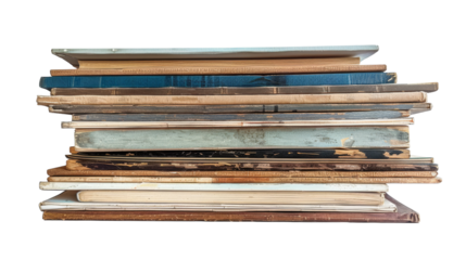 A tall stack of weathered, vintage books sits in perfect balance, each one telling its own story