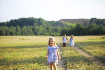 Children walk in the summer in nature. Child on a sunny spring morning in the park. Traveling with...