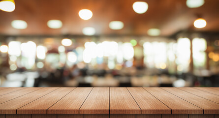 Empty wooden table top with lights bokeh on blur restaurant background. - obrazy, fototapety, plakaty