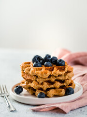 Easy healthy gluten free oat waffles with copy space. Stack of appetizing homemade waffles with oat...